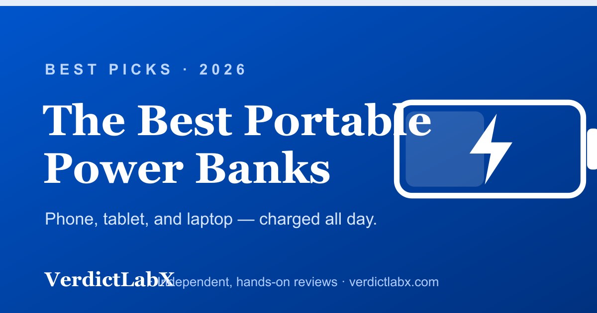 A portable power bank charging a phone and a laptop on a desk