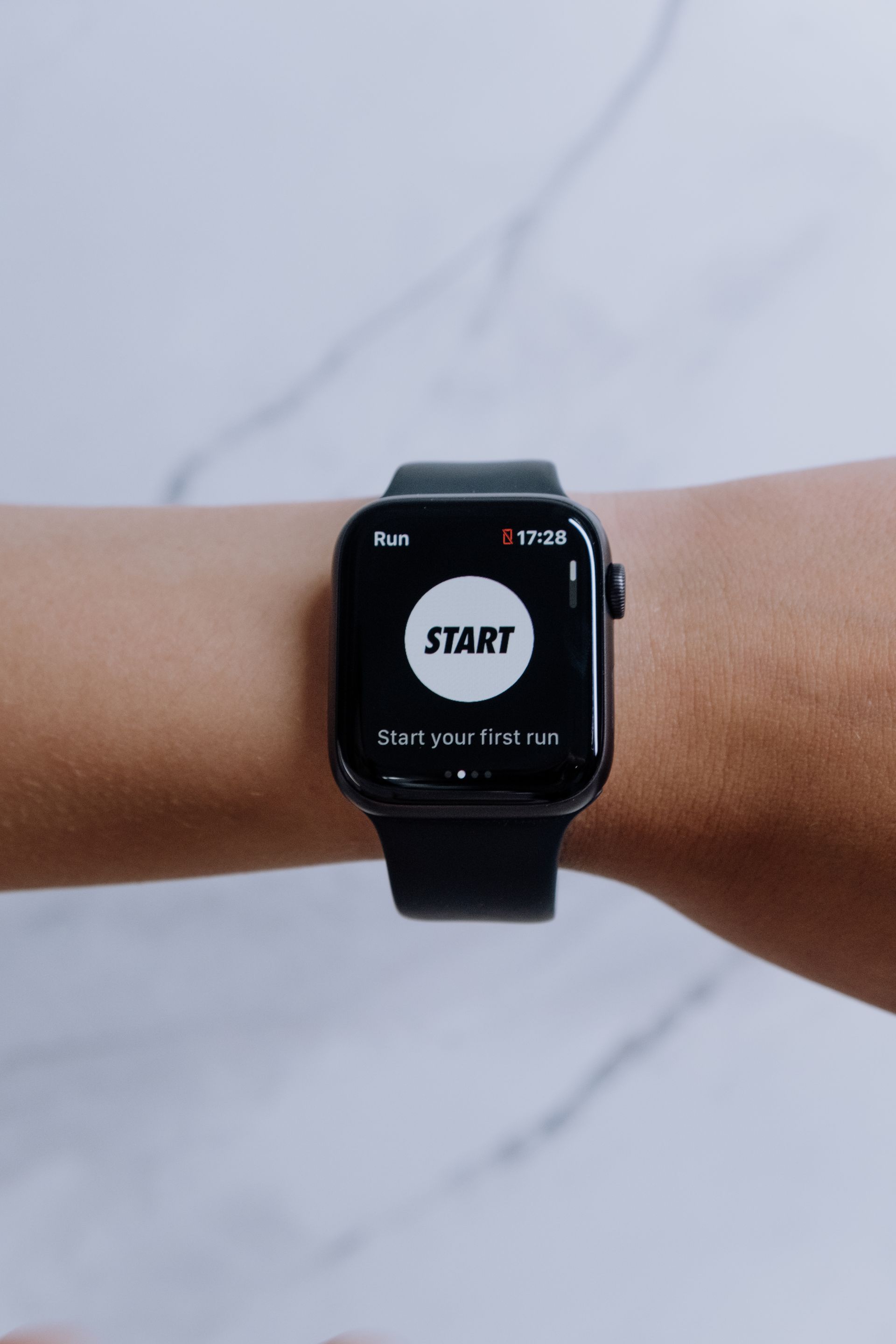 A smartwatch on a wrist beside a smart ring