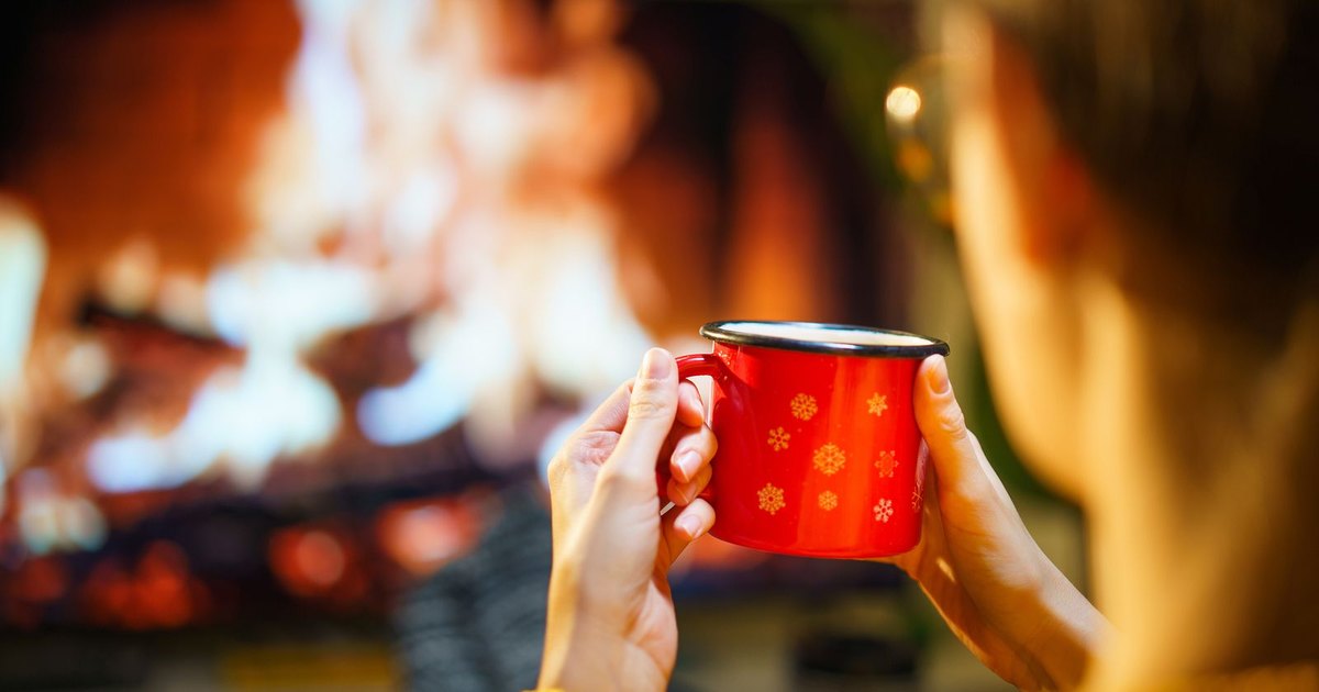 A modern space heater warming a cozy bedroom on a winter evening